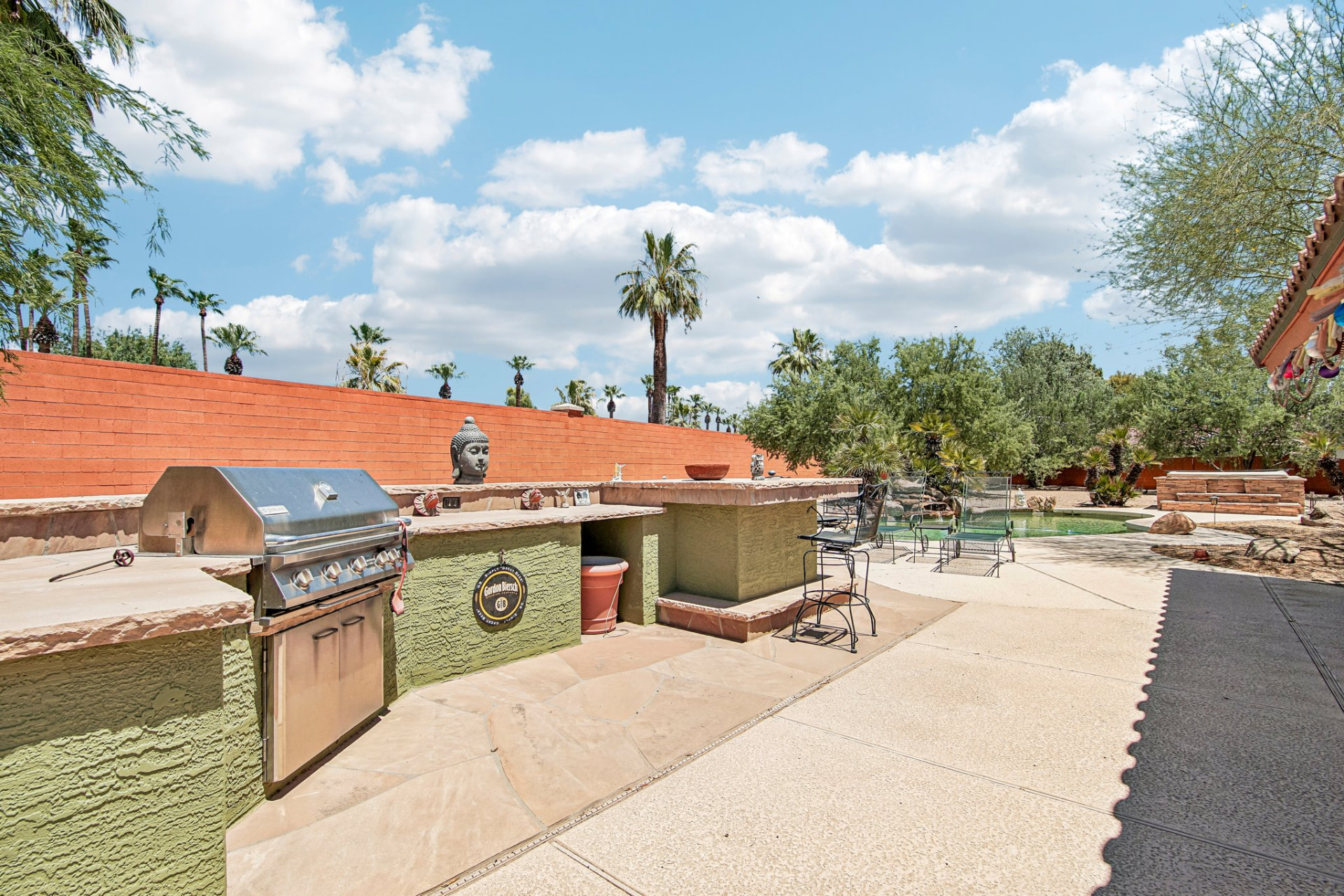 Built-in outdoor kitchen with gas grill and bar seating